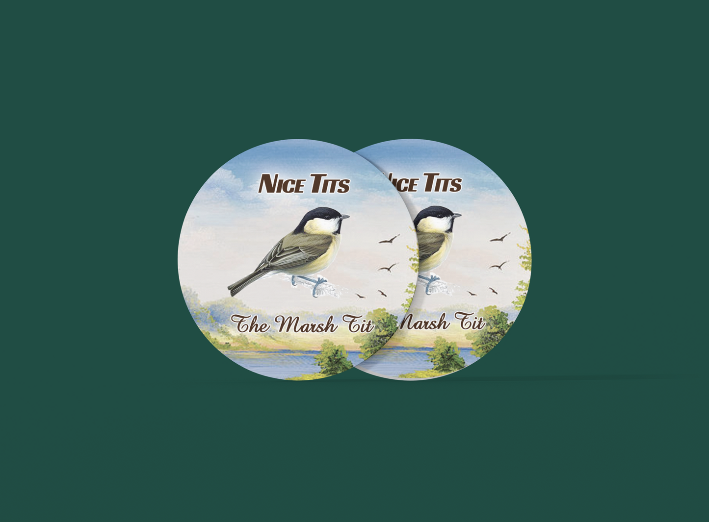 two buttons with two birds on them on a green background