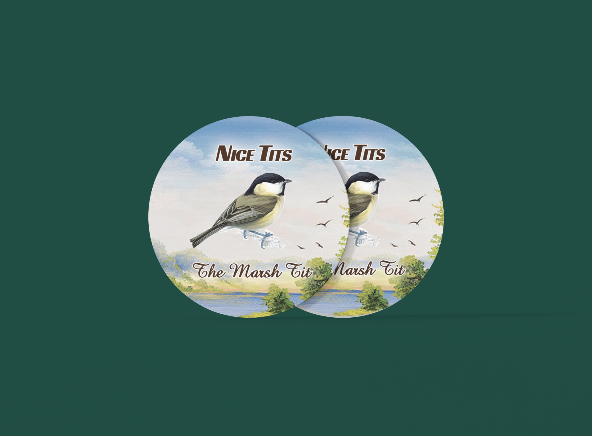 two buttons with two birds on them on a green background