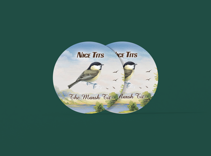 two buttons with two birds on them on a green background