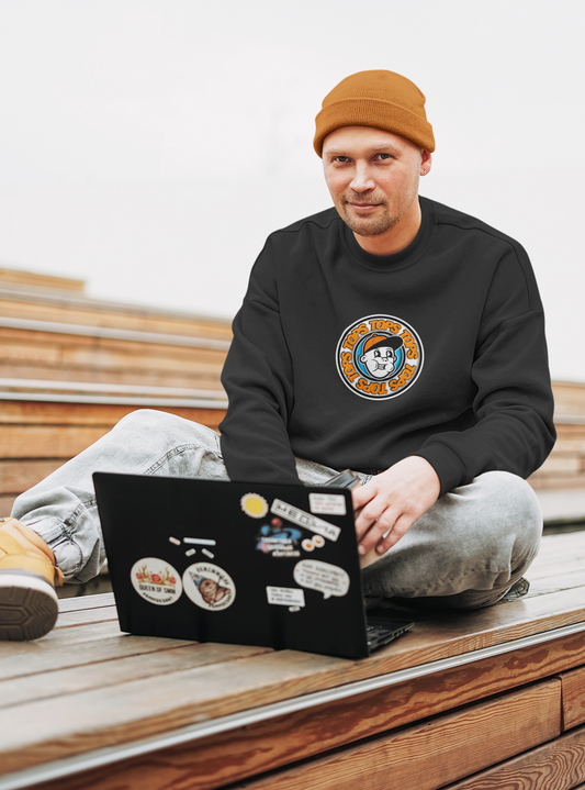 a man sitting on a bench with a laptop