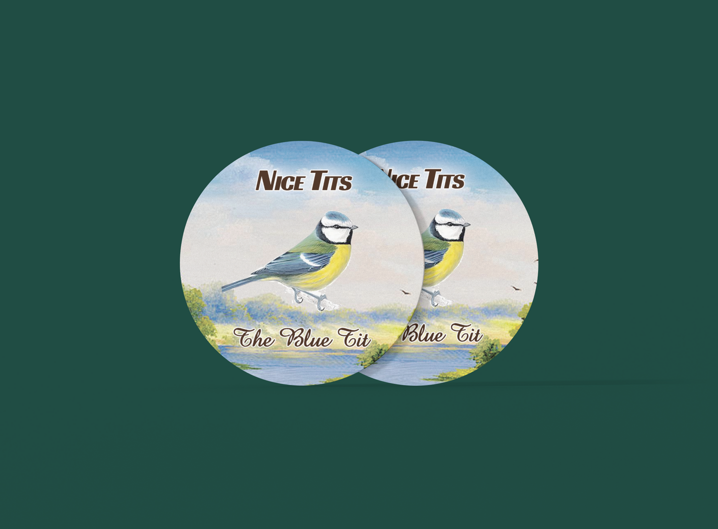 two buttons with two birds on them on a green background