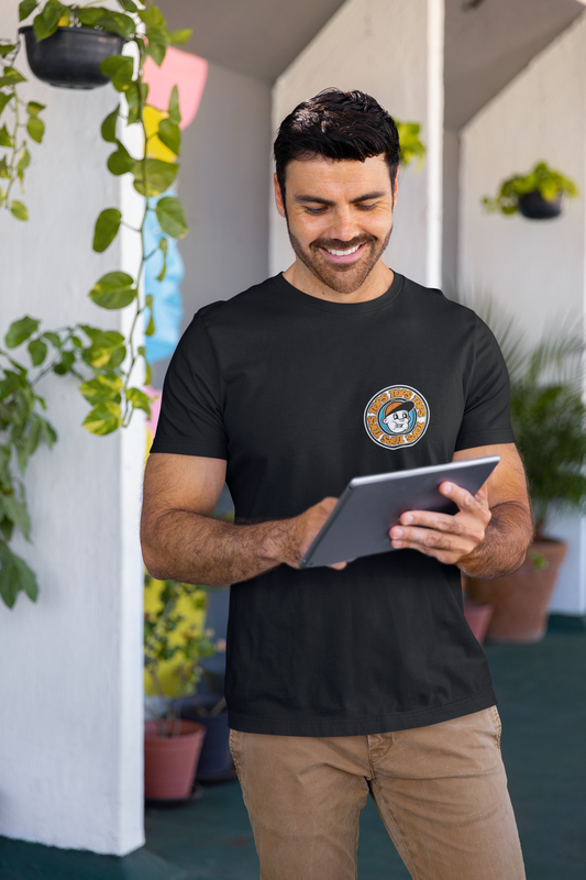 a man is smiling while looking at a tablet